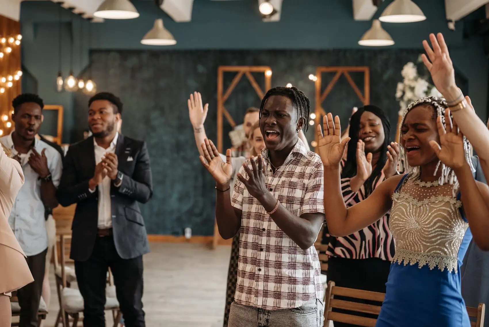 Congregation worshipping with hands raised